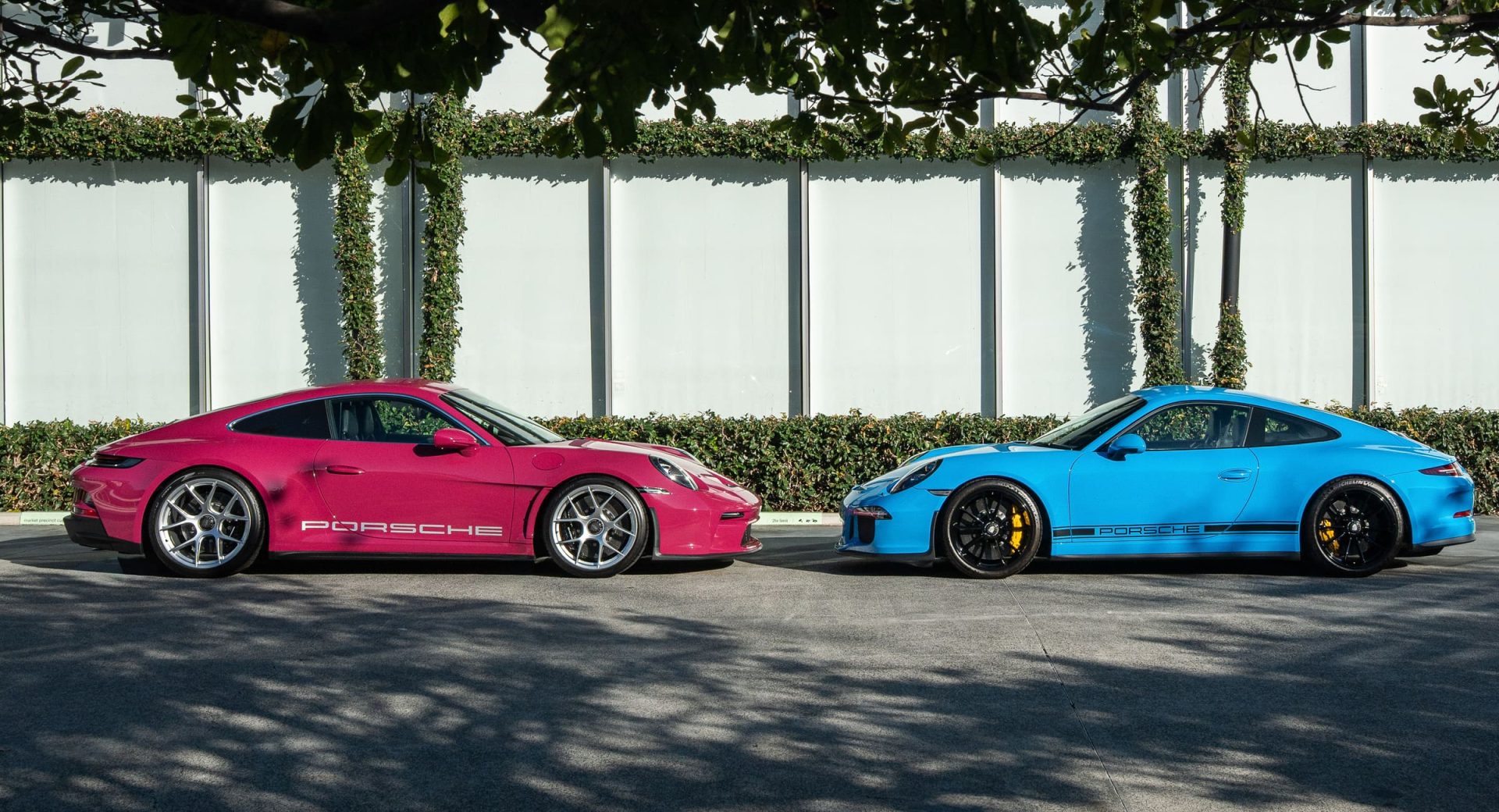 Pink Porsche 911 ST and Mexico blue Porsche 911 R parked side by side